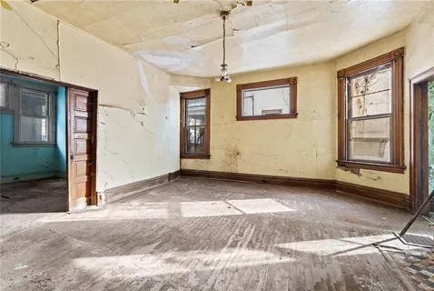 a view of a livingroom with a ceiling fan and window