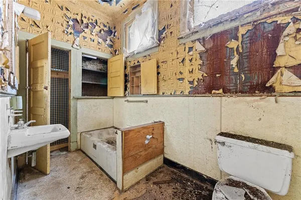 a bathroom with a sink and mirror with toilet