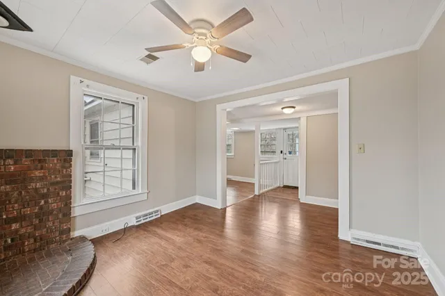 an empty room with wooden floor and closet