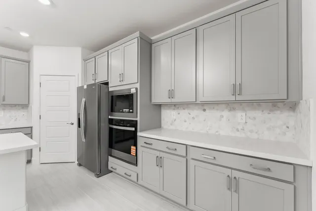 a kitchen with stainless steel appliances white cabinets and a sink