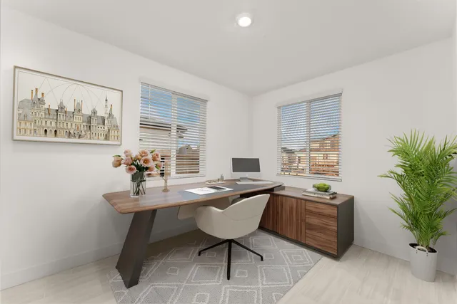 a view of a workspace with furniture and window