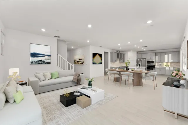 a living room with furniture and view of kitchen