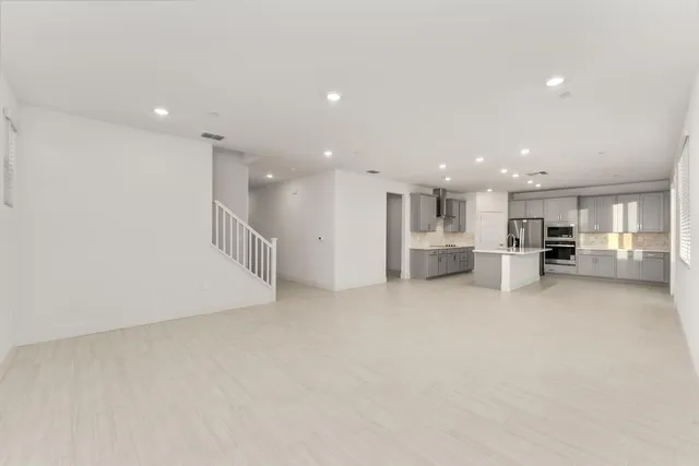 a view of kitchen with refrigerator and a window