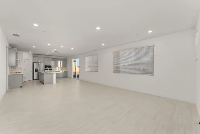 a view of an empty room with a kitchen