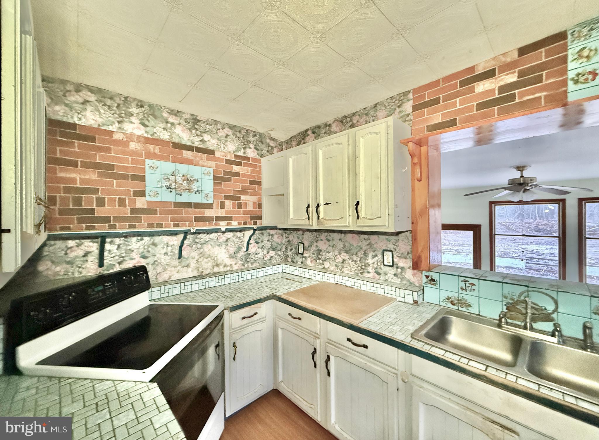 830 North Tuckahoe Road Williamstown, NJ 08094 - Photo 13 of 28 a kitchen with a sink and a stove top oven
