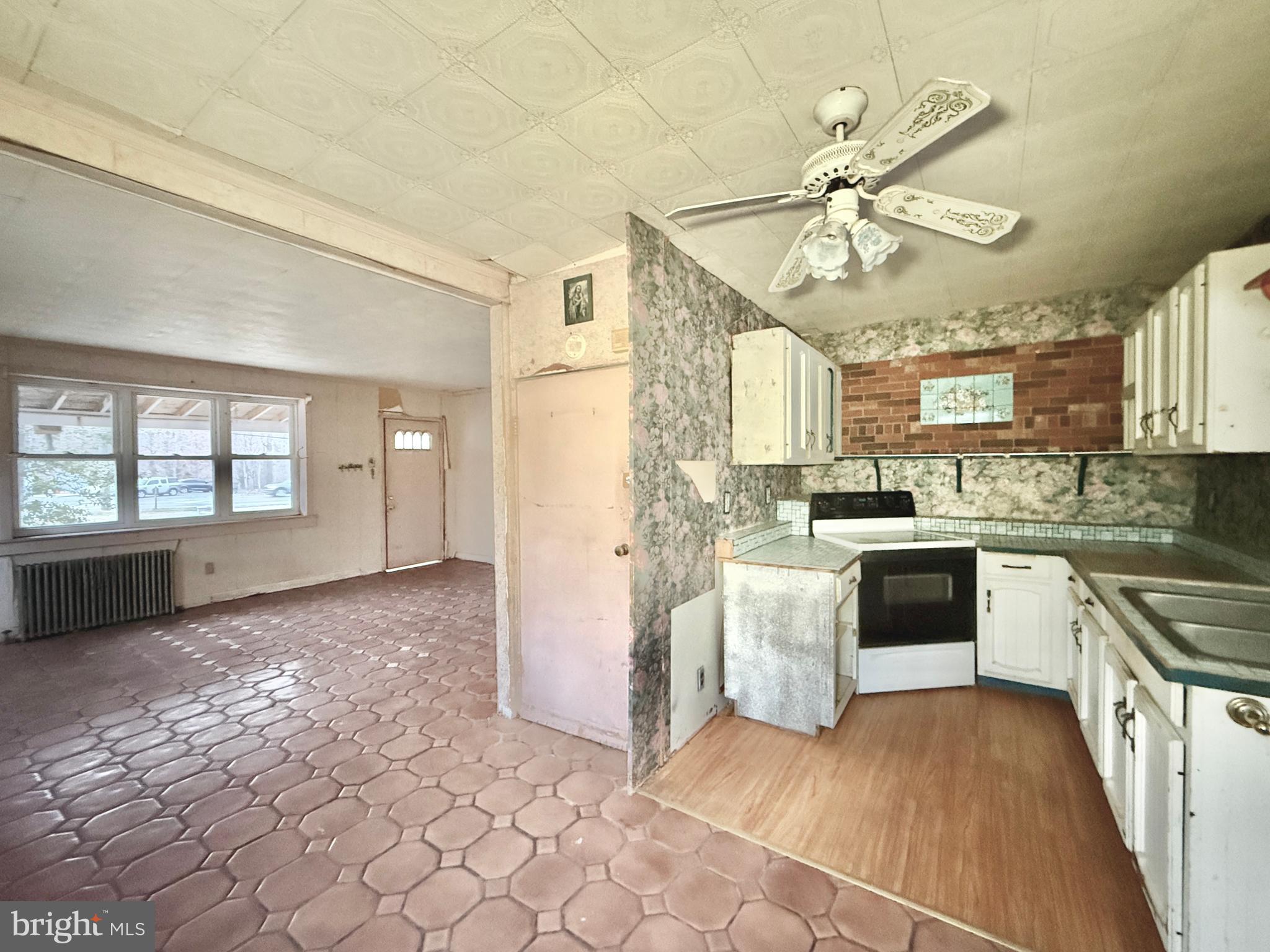 830 North Tuckahoe Road Williamstown, NJ 08094 - Photo 16 of 28 a kitchen with stainless steel appliances granite countertop a stove cabinets and a living room