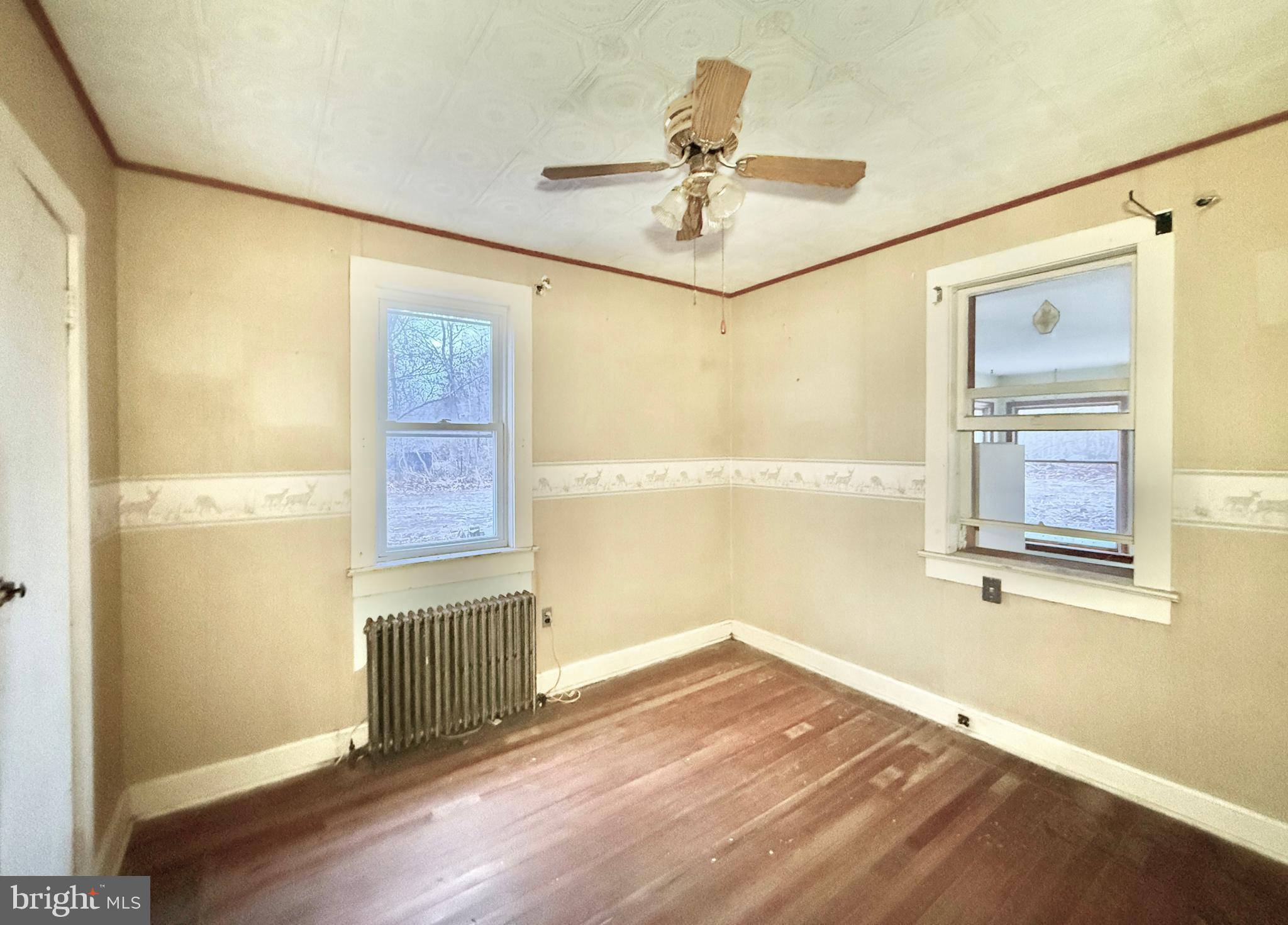 830 North Tuckahoe Road Williamstown, NJ 08094 - Photo 20 of 28 an empty room with wooden floor fan and windows