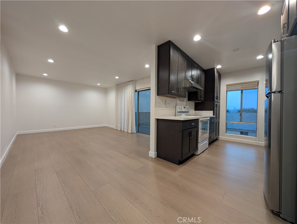 a large kitchen with stainless steel appliances kitchen island a large counter top and a sink