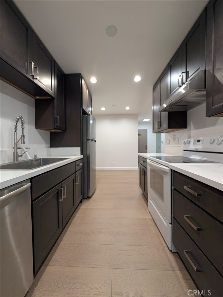17052 Colima Road, Unit 206 Hacienda Heights, CA 91745 - Photo 2 of 15 a large kitchen with stainless steel appliances kitchen island a large counter top a sink and a stove