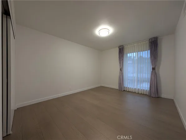 an empty room with a empty space and windows
