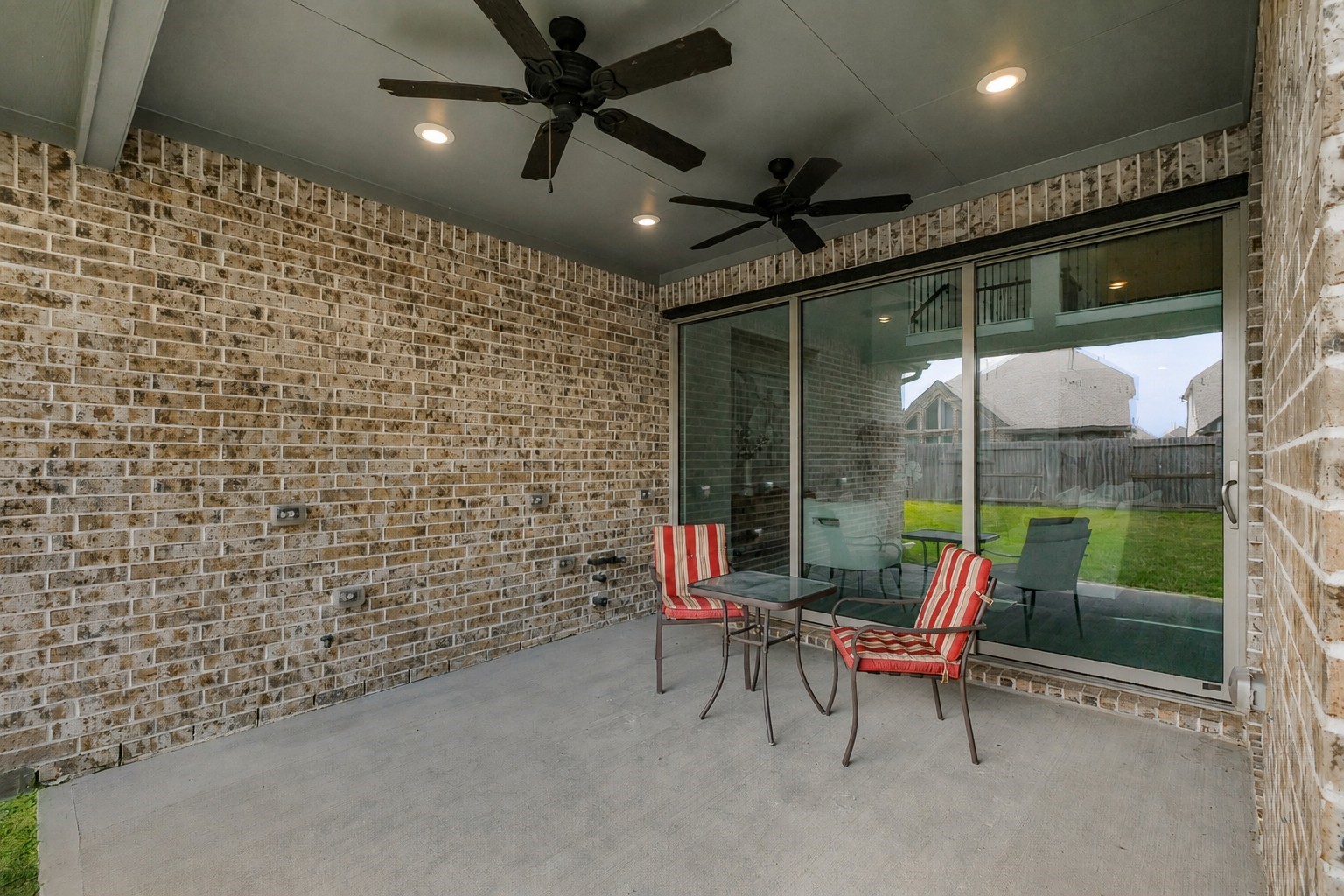10514 Rigel Rdg Way Richmond, TX 77406 - Photo 45 of 50 The covered patio offers plenty of room to create an outdoor dining or lounge area, with large sliding glass doors connecting it directly to the main living space.