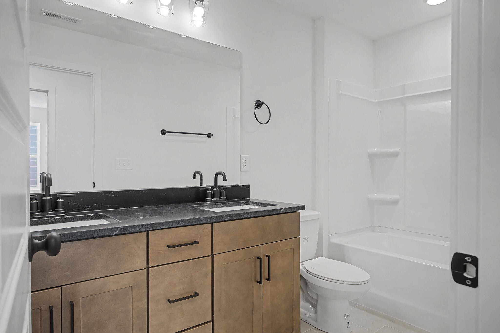1616 Cotton Way Chattanooga, TN 37404 - Photo 19 of 38 a bathroom with a granite countertop sink a toilet and bathtub