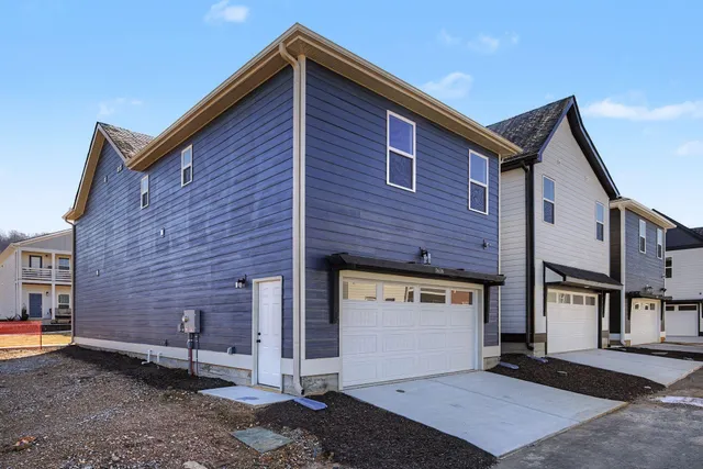 a front view of a house with parking space