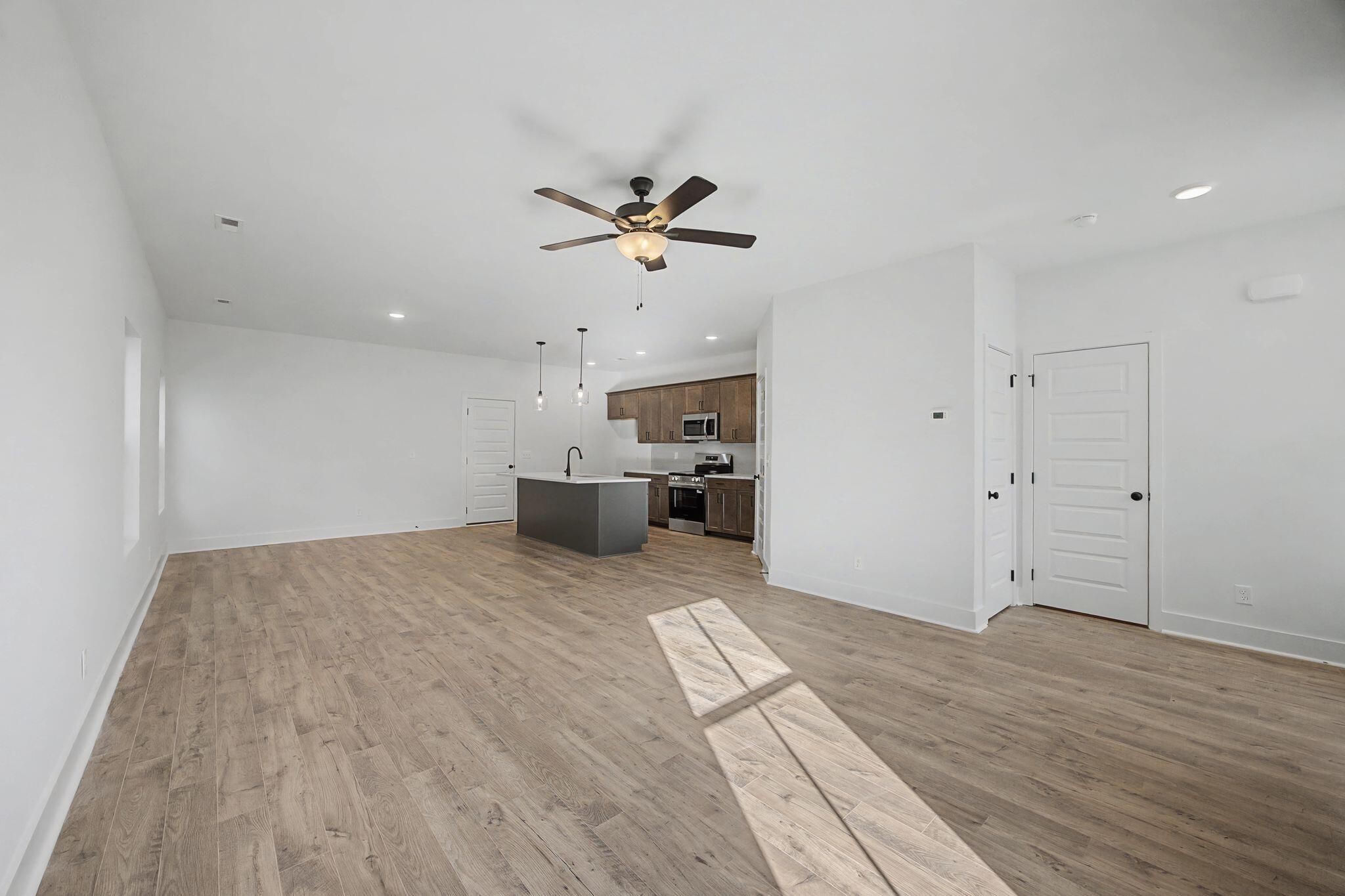 1616 Cotton Way Chattanooga, TN 37404 - Photo 5 of 38 a view of a big room with wooden floor and a ceiling fan