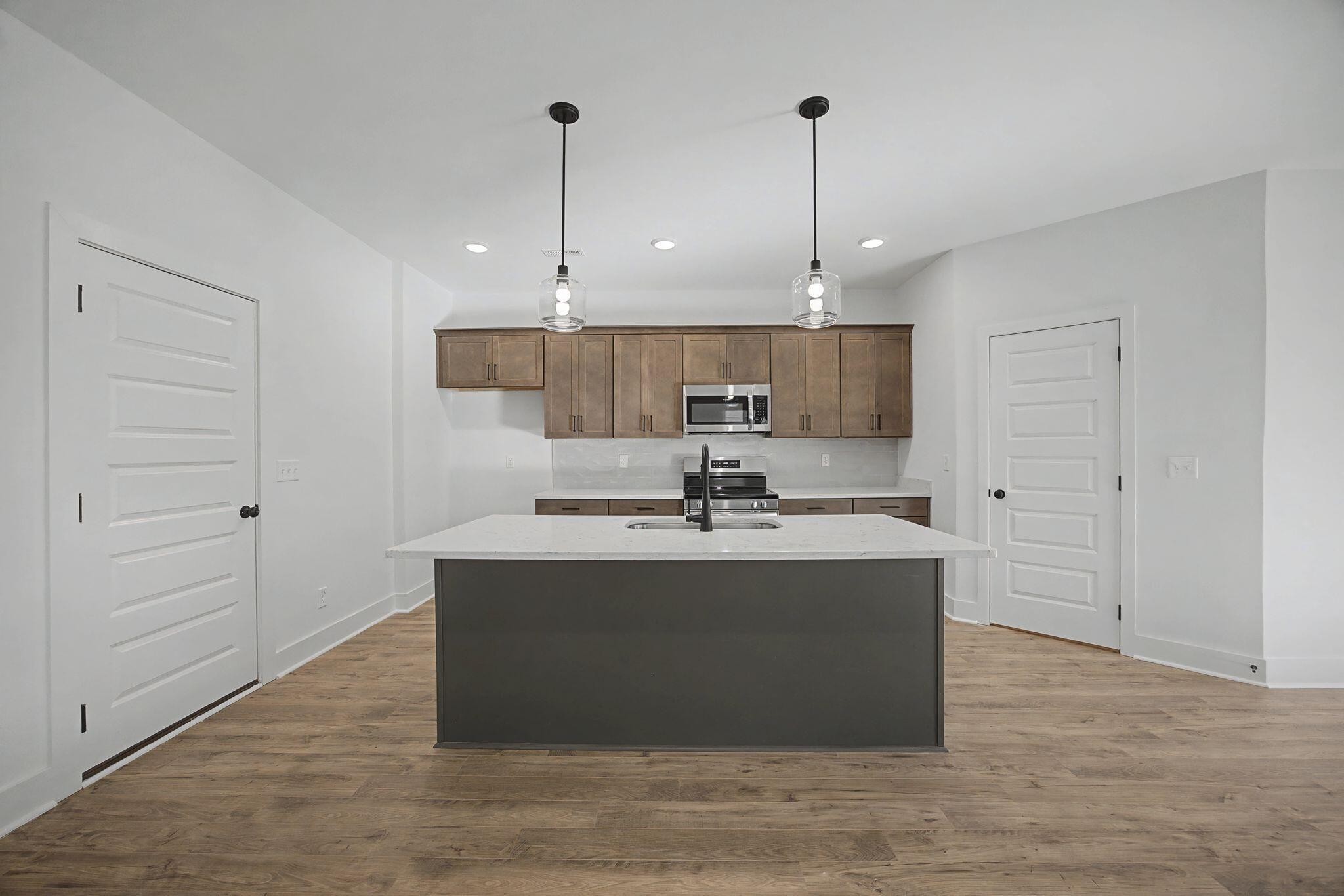 1616 Cotton Way Chattanooga, TN 37404 - Photo 7 of 38 a view with kitchen island a sink a stove and kitchen island