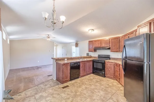 a large kitchen with cabinets and stainless steel appliances