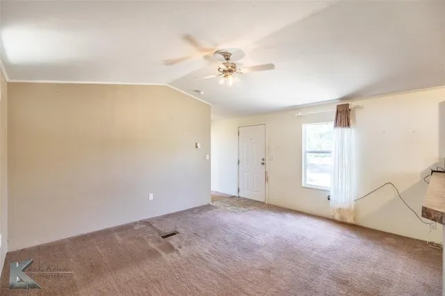 a view of a livingroom with a ceiling fan and window