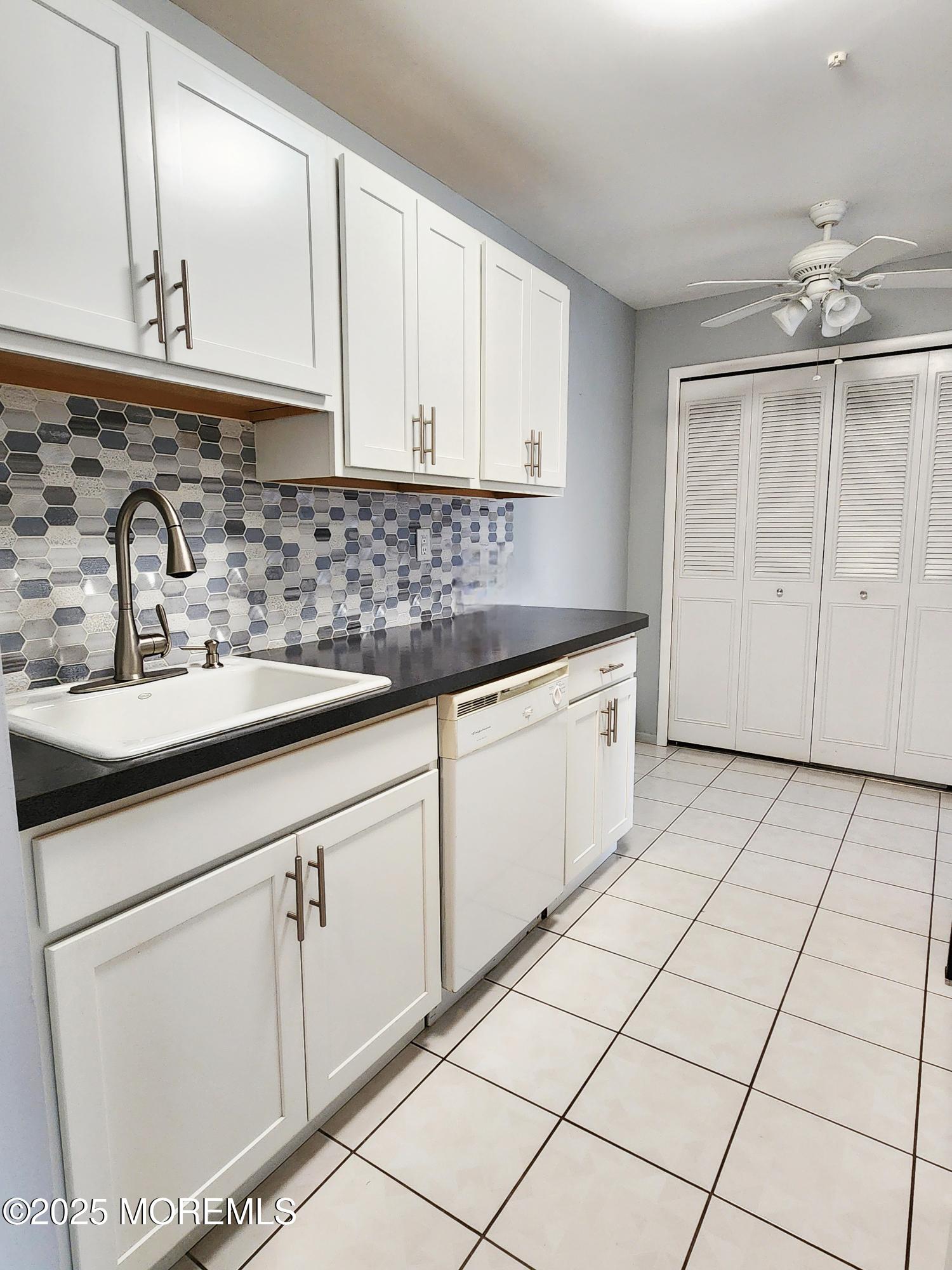 a kitchen with a sink cabinets and window