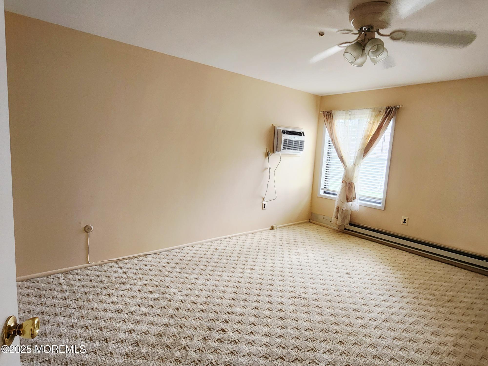 78 Overlook Way, Unit C Manalapan, NJ 07726 - Photo 9 of 15 a view of an empty room and window