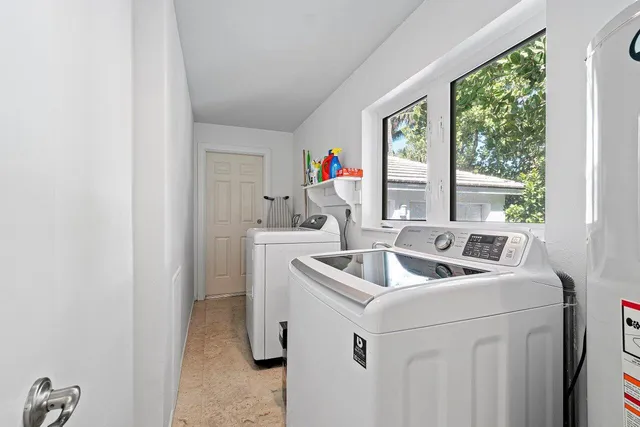 a kitchen with stainless steel appliances kitchen island granite countertop a refrigerator and a stove top oven