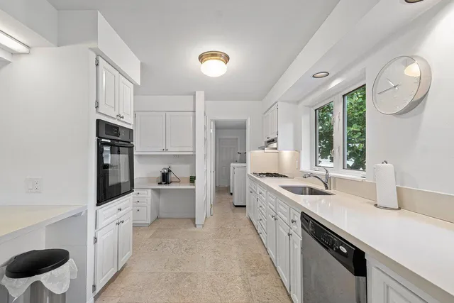 a view of a house with a yard and potted plants
