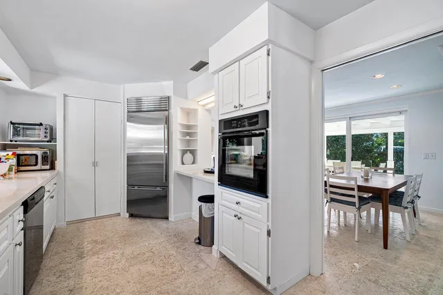 a front view of a house with patio and garden