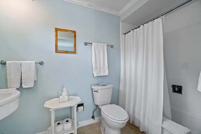 a white toilet sitting next to a bathroom sink