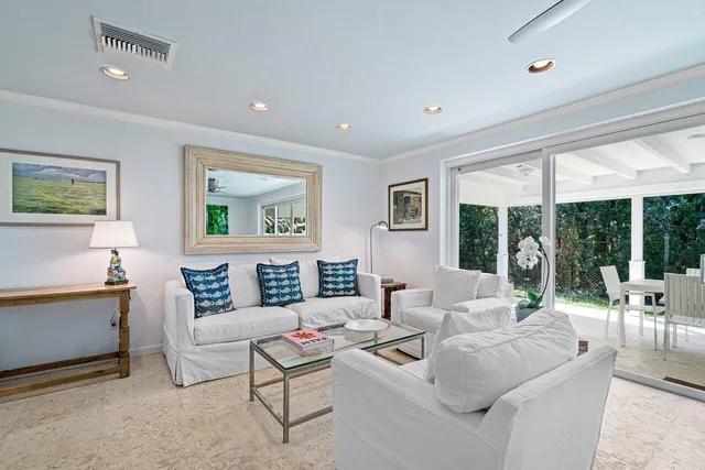 a living room with furniture and large windows