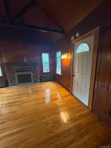 a view of empty room with window and fireplace