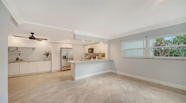 a kitchen with white cabinets and white appliances