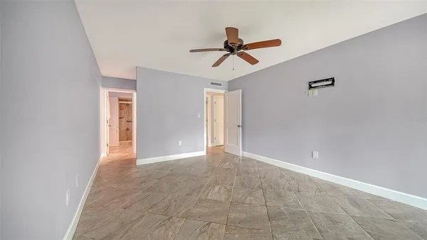 a view of a livingroom with a ceiling fan and window