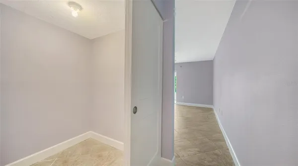 a view of empty room with ceiling fan