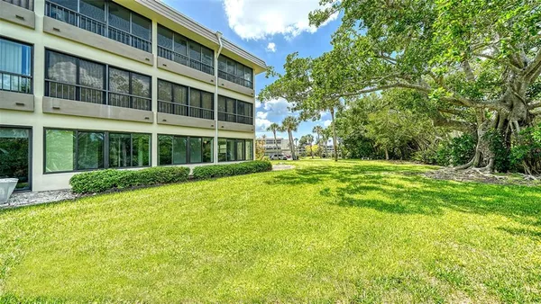 an aerial view of house with yard and lake view