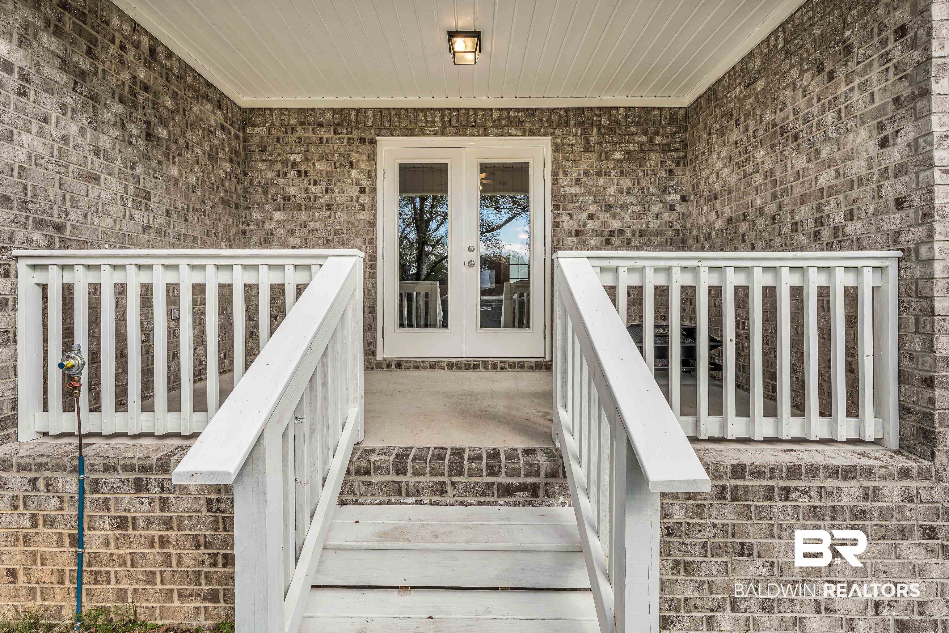 9206 Greenleaf Drive Daphne, AL 36527 - Photo 24 of 32 View of exterior entry with brick siding and french doors