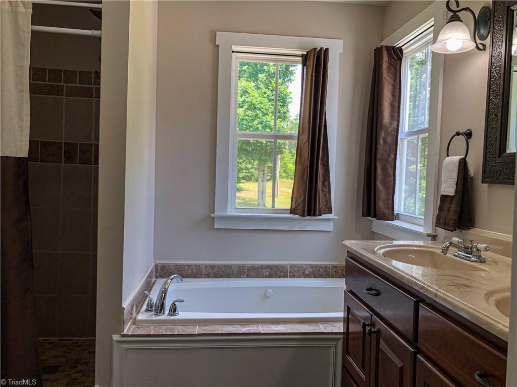 1127 Wood Stack Trail Road Westfield, NC 27053 - Photo 11 of 30 Master bath has jetted tub, double sink vanity, and walk in shower.