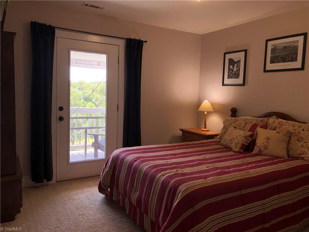 1127 Wood Stack Trail Road Westfield, NC 27053 - Photo 12 of 30 Bedroom with entrance to rocking chair front porch. 2nd level with a beautiful view of the mountain overlooking the front yard.