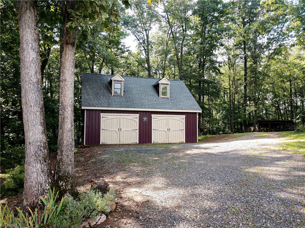 1127 Wood Stack Trail Road Westfield, NC 27053 - Photo 18 of 30 The work shop has 2 garage door entrances and a single door front and back entrance with guest quarters in the top and storage shed attached to the back.