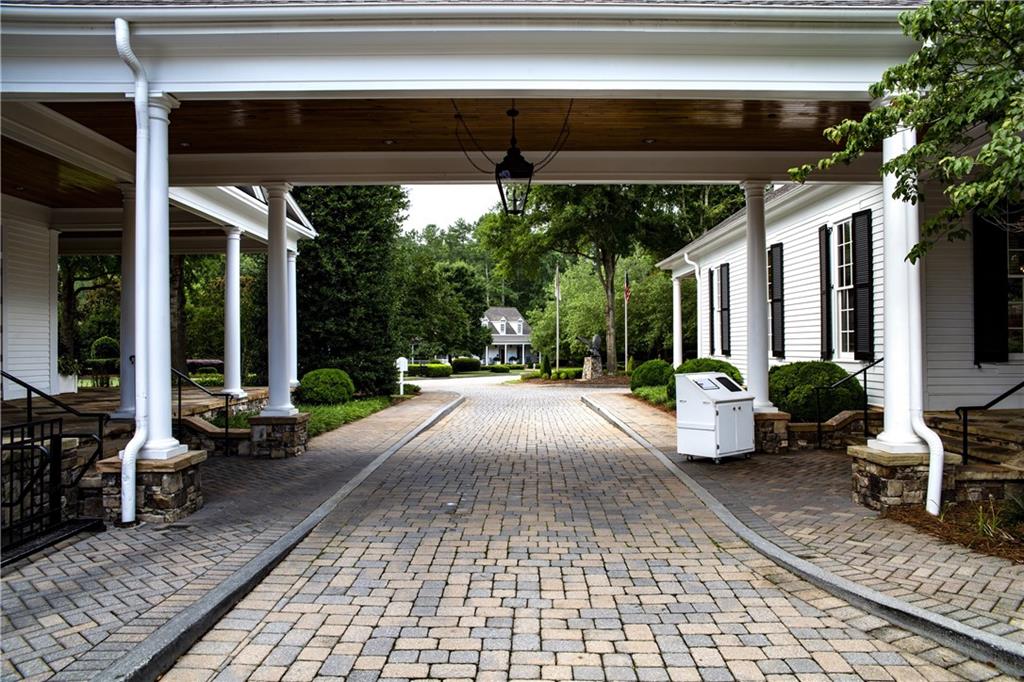 130 Talon Way Canton, GA 30115 - Photo 6 of 7 a view of a patio with table and chairs potted plants and floor to ceiling window
