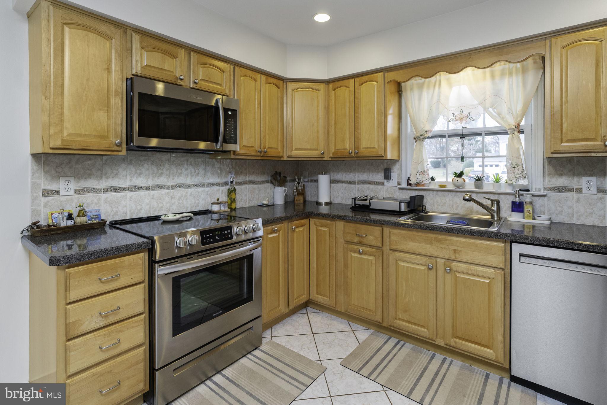 31 Wolfpack Road Hamilton, NJ 08619 - Photo 17 of 36 a kitchen with stainless steel appliances granite countertop a stove a sink and a microwave