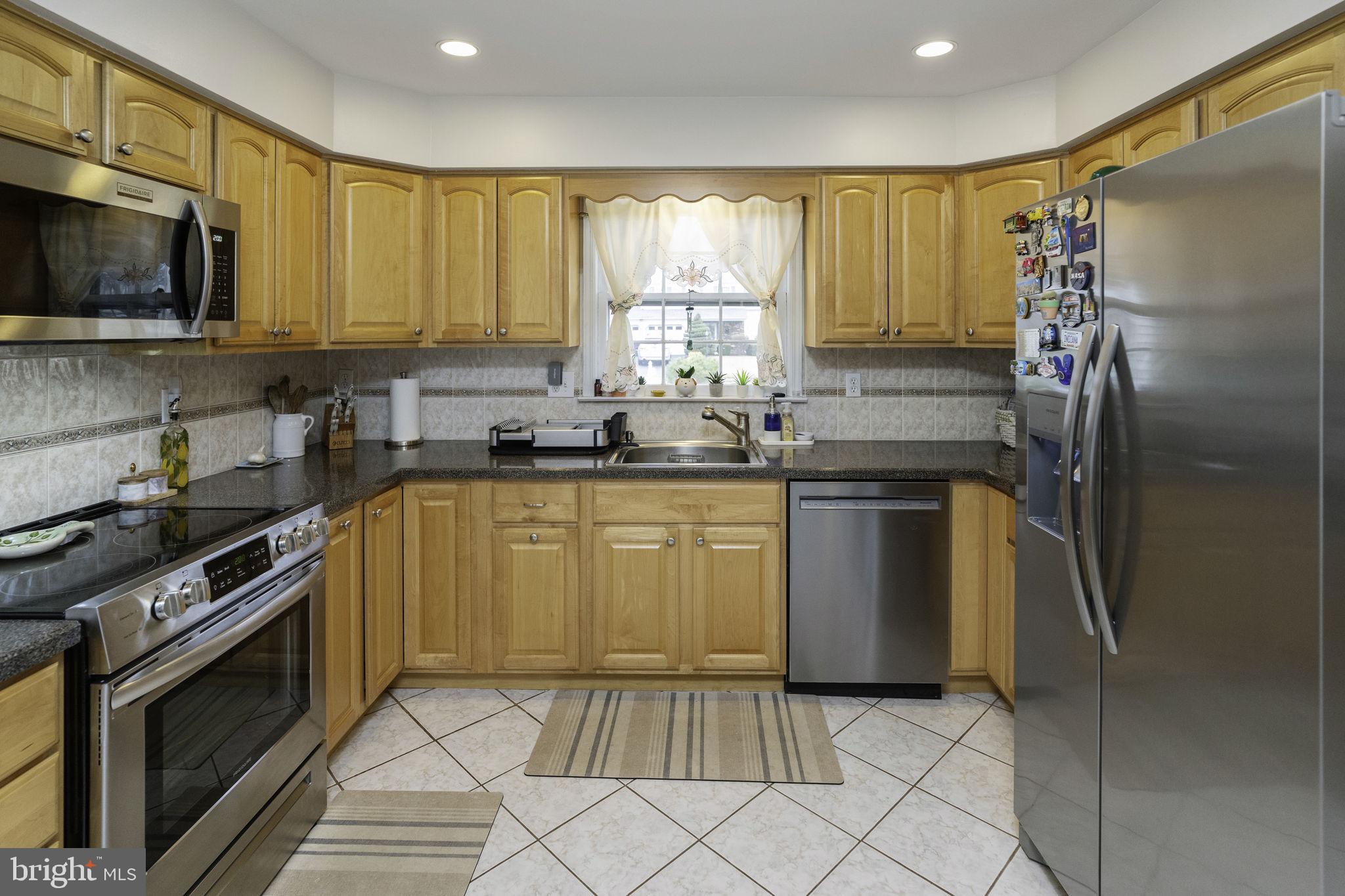 31 Wolfpack Road Hamilton, NJ 08619 - Photo 20 of 36 a kitchen with stainless steel appliances a stove a sink and a microwave