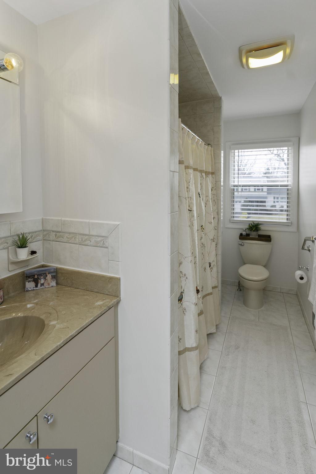 31 Wolfpack Road Hamilton, NJ 08619 - Photo 28 of 36 a bathroom with a granite countertop sink a toilet and shower