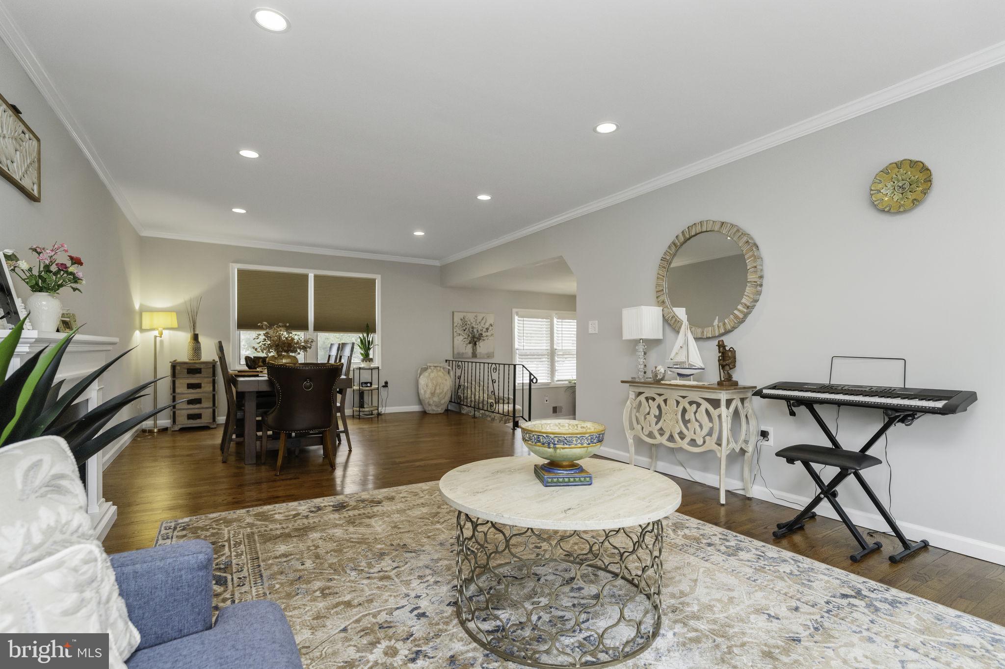 31 Wolfpack Road Hamilton, NJ 08619 - Photo 7 of 36 a living room with furniture and a dining table with wooden floor