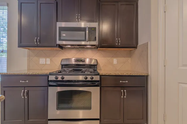 a stove top oven sitting inside of a kitchen