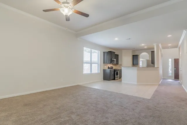 a view of a kitchen with a sink and a chandelier fan