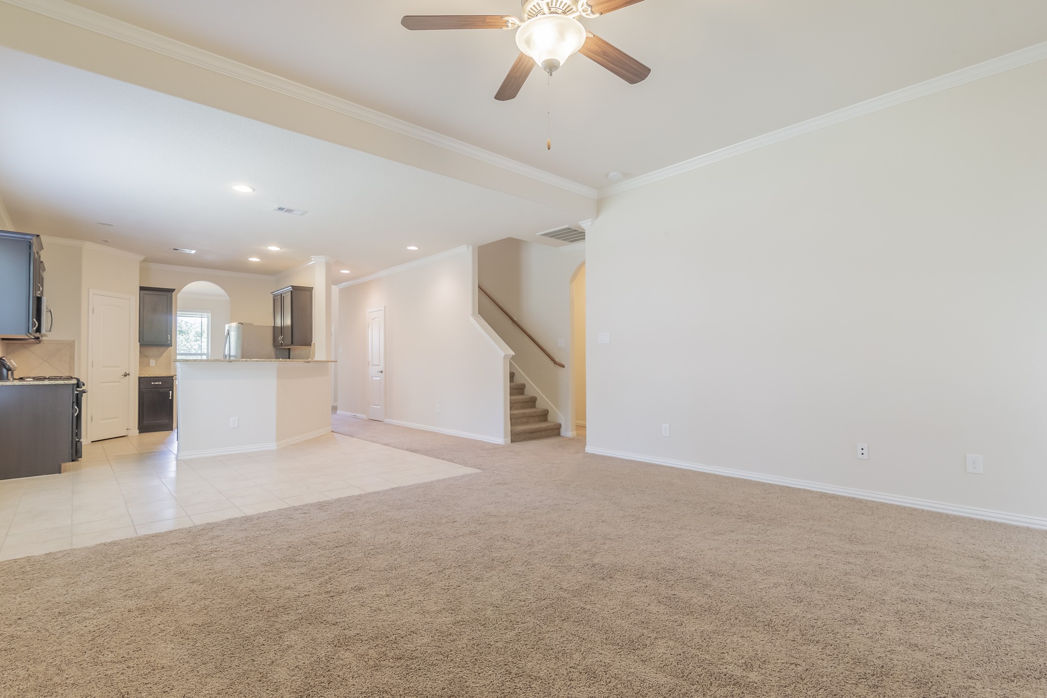 5 Iris Arbor Court Conroe, TX 77301 - Photo 16 of 35 a view of a kitchen with a sink and a chandelier fan