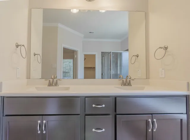 a spacious bathroom with a tub sink and mirror