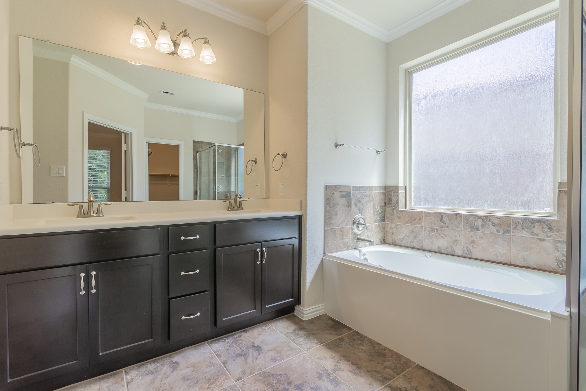 5 Iris Arbor Court Conroe, TX 77301 - Photo 26 of 35 a spacious bathroom with a tub sink and mirror