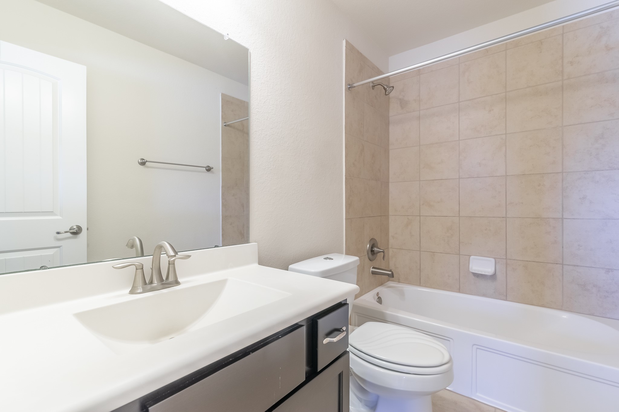 5 Iris Arbor Court Conroe, TX 77301 - Photo 30 of 35 a bathroom with a sink a toilet a mirror a bathtub and shower