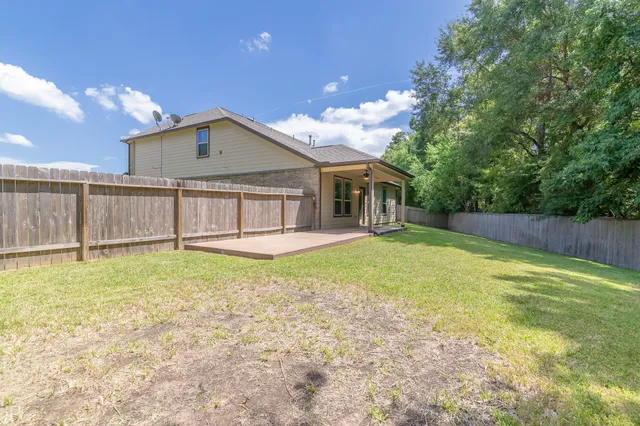 a view of a house with a backyard