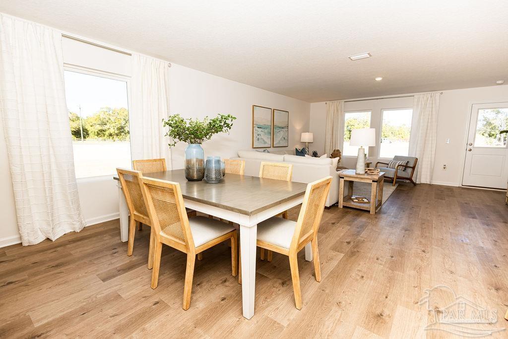 5368 Azimuth Way Milton, FL 32583 - Photo 4 of 19 a dining room with furniture and wooden floor